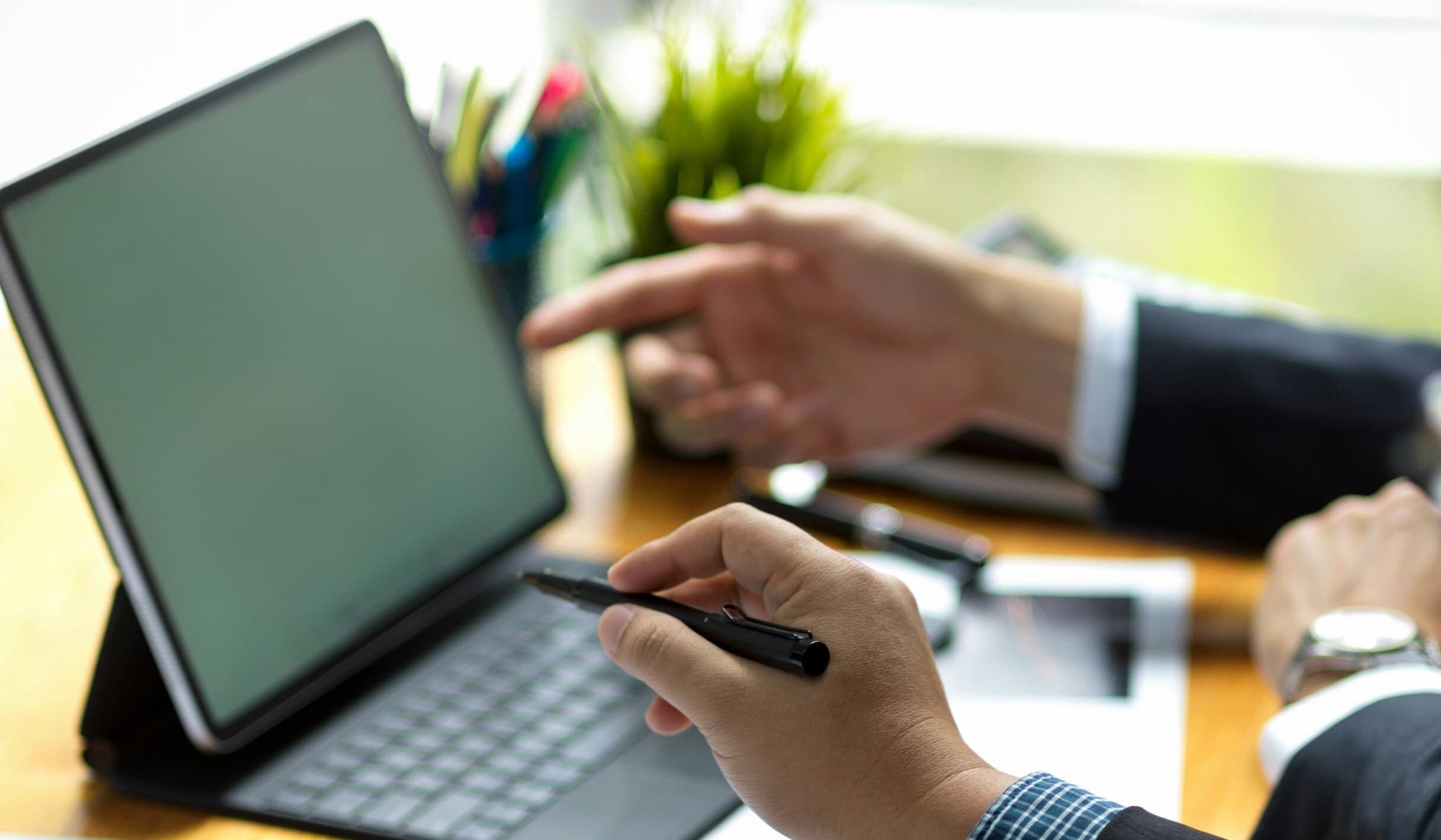 two businesspeople pointing at a computer